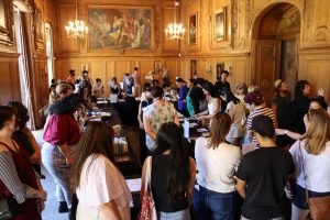 Photograph of the Clark Library's Drawing Room with attendees perusing books and rare materials at the 2023 Open House